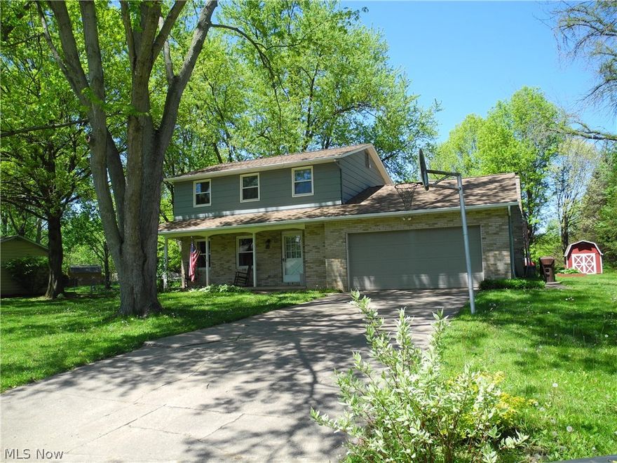 First floor dine-in kitchen, dining room, living room, family room and half bath. Second floor has 3 bedrooms and full bath.  Basement has finished room with closet, built in shelves and a bar.  Unfinished laundry room and large cement floored crawl space for storage under lst floor family room.
Covered front porch on wooded lot with a large back deck off the family room. Large flat lot with 10 x 12 storage barn.  Home is located at the end of the street with light woods at the end.
2 car attached garage, central air, gas forced air furnace.  Comes with refrigerator, electric stove, washer , dryer, water softener, dishwasher, garbage disposal.  Newly installed roof on the home and barn in March, 2019. Aeration Septic System to be installed before sale of the home at sellers cost. Vinyl flooring just installed in kitchen as well as new carpet installed on the steps to basement and thru out the lower level rec room April 2019  Possession at closing.