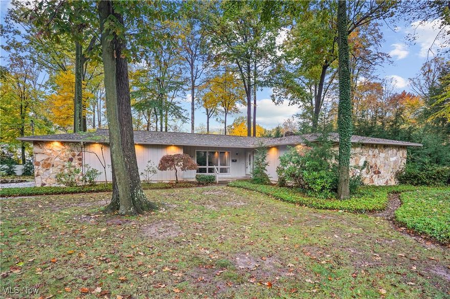 Poland Woods Living - Custom designed Ranch with a Private, Park-Like Setting.
This STUNNING Home, built in 1971, sits just a block from the Mauthe Bridge entrance to Poland Municipal Forest. Crafted with timeless detail, it features striking Georgia Fieldstone inside and out—from the exterior to the floor-to-ceiling fireplace in the great room—seamlessly adds natural materials with architectural charm.
Designed to Bring the Outdoors In...
Floor-to-ceiling windows span the back of the home, flooding the interior with natural light, especially in late afternoon and at sunset. The great room features an open floor plan with soaring 10-foot A-frame pine ceilings. From the great room, kitchen, and dining area, take in views of the picturesque backyard, where oak and beech trees provide summer shade and vivid autumn color. In winter, cozy up by the wood-burning fireplace, watching cardinals and chickadees flit among the hemlocks.
The kitchen and great room open onto a C. Robert Buchanan-designed deck—perfect for grilling. With four access points, enjoy seamless indoor-outdoor living spring through fall.
Thoughtfully Designed Spaces...
The eat-in kitchen offers generous cabinetry, stainless steel appliances, tons of counter top space, and a dining area with floor-to-ceiling windows. Convenient access to the screened-in porch (3-season potential) and garage with extra storage.
A front library captures morning light and features hardwood floors, built-in shelving and cabinets with marble countertop—the ideal home office.
The primary suite includes a walk-in closet, dual vanities, and private bath. Two additional bedrooms with generous closets share another full bath.
The finished lower level provides a rec room, bar, full bath, laundry, storage, and large crawlspace.
Prime Location...
Situated in Boardman Township with Poland Schools—walkable to Poland Village, and a short drive to shopping, dining, YSU, and Mill Creek Park.