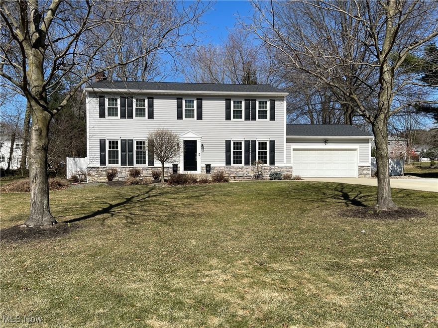 Welcome to this impeccably maintained, quality-crafted Mitov-built Colonial in the highly sought-after town of Hudson! Nestled on a quiet cul-de-sac, this elegant 4-bedroom, 2.5-bath home boasts a private and beautifully enclosed backyard perfect for relaxation and entertaining. The heart of the home is the spacious kitchen, featuring a generous center island, gleaming quartz countertops, KraftMaid cabinetry, and newer stainless-steel appliances. The formal dining room is ideal for hosting memorable gatherings, while the adjoining family room exudes warmth with a striking stone fireplace and an abundance of natural light. A stunning new front door welcomes you into the foyer, where newer flooring flows seamlessly throughout the main level. Thoughtfully updated, the first floor includes a stylish half bath and a modernized laundry room with direct access to the attached two-car garage. Upstairs, the owner’s suite is a retreat of its own, complete with a custom-designed walk-in closet and a luxurious ensuite featuring elegant new flooring. Three additional spacious bedrooms offer generous closet space and share a beautifully remodeled full bath with quartz countertops and modern fixtures.  Additional updates throughout the home include outlets, light switches, and interior paint. The furnace and A/C replaced in 2024 provide year-round comfort and peace of mind. The sizable, dry, open basement is ready for your inspiration. Exterior enhancements such as a new roof, newer premium siding, stone veneer accents, newer garage man door, flawless cement garage floor, driveway, and driveway extension ensure low-maintenance, worry-free living. Step outside to your serene backyard oasis, where a charming brick and stone patio with a firepit awaits your summer barbecues. With newer vinyl fencing, gutter guards, and countless additional upgrades, this home is truly move-in ready! Conveniently located near parks, restaurants, and shopping. Schedule your showing today!