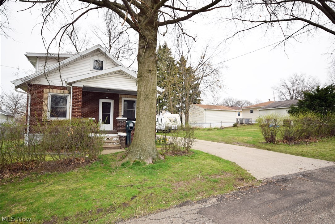 All Brick, extra lot included, 2 car garage with concrete driveway, Large living room with window seat, 1st floor bedroom w/half bath, formal dining room, brick patio with privacy fence and inviting front porch. Large second floor bedroom with full bath and loft. Full basement with glass block windows. Water tank 2013. All appliances stay.