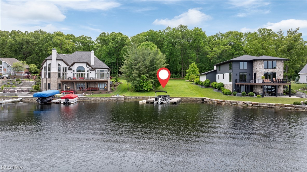 Build your dream lakefront home in the prestigious Diamond Shores community—the only gated neighborhood on the Portage Lakes and part of the highly rated Green Local School District. This beautiful, buildable gently sloping lot offers 68 feet of frontage on the quiet and scenic Cottage Grove Swim Lake, part of the desirable Main Chain of the Portage Lakes. Perfect for a walkout lower level home. With nearly a quarter acre of land, you'll enjoy both sunrise and sunset views in a tranquil, upscale setting. The lot features public sewer access and underground utilities already in place, along with a newer seawall and private docks- parking for three boats. You’ll love the freedom to bring your own builder and design a custom home that fits your vision, surrounded by luxury residences in a peaceful, private setting. Just a short ride from East Reservoir's speed and ski lanes, and bordered by protected State Park land, this location offers both quiet natural beauty and easy access to water recreation. Opportunities like this are rare—don’t wait to build the lakefront lifestyle you’ve been dreaming of.