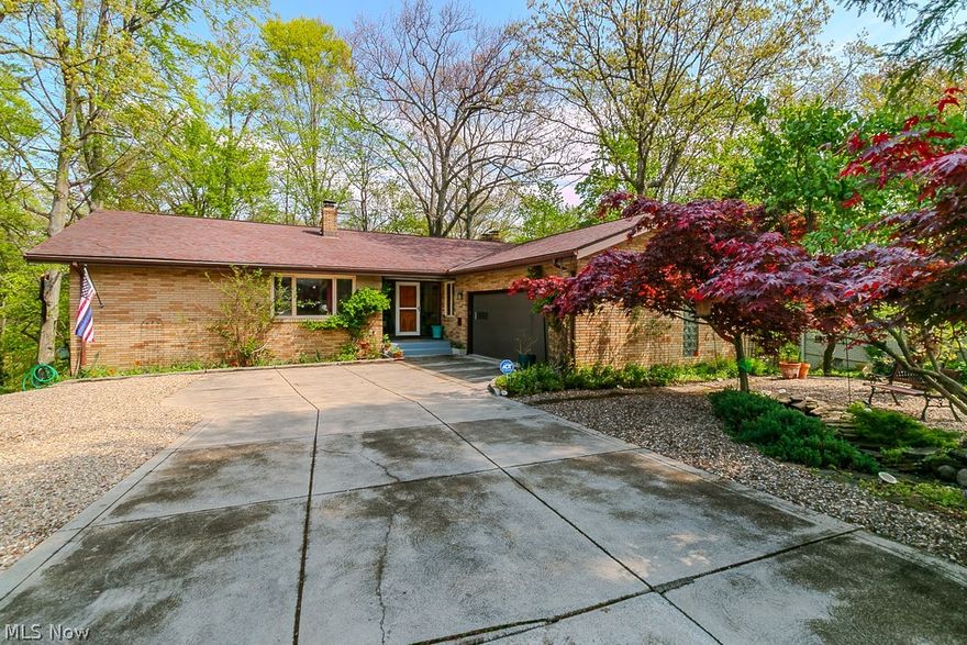 Experience Serene Luxury in this Sprawling all Brick Ranch in Seven Hills.  Boasting of three bedrooms, three full bathrooms and Floor-to-ceiling windows that frame breathtaking valley views.  Each season is a treat!  The autumn foliage is amazing. Even in the winter, you can see the Cleveland skyline.  Enjoy your morning coffee on the balcony while taking in this stunning panorama. Hummingbirds could entertain you for hours. Every corner of this home invites you to unwind. Hardwood floors are throughout the main living area.  Many updates include the remodeled kitchen with newer appliances and a ceramic tile floor. See supplements for a complete list. There is also a formal dining room. Only the second owners, you'll appreciate how everything is tastefully decorated and meticulously maintained. Most of the interior was freshly painted.  The walkout basement features a fireplace and offers even more space and versatility, perfect for entertaining or relaxing.  The basement also has a sectioned-off enclosed area with a large workshop, an enclosed pantry and plenty of storage racks.  You'll appreciate the spacious 2 car garage with newer garage door (2024) and ample shelving for storage.!   Tucked away on a cul-de-sac, it is surrounded by beautiful landscaping, a rock garden and nature. The dramatic views from every window will amaze you.  It's like living in your year-round vacation home. Don't miss this one-of-a-kind gem!!   Twilight Open House  Wednesday 5/13/26     Hours 5-7