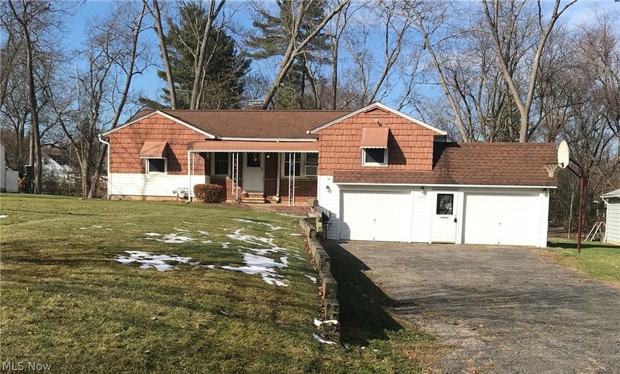 This spacious, unique, 3 bedroom ranch in Solon has much character!  You can find an eat in kitchen on the first floor which includes, a rustic brick back splash, and newer appliances (gas range-18, dishwasher-06,microwave-13, fridge is negotiable). A nice size living room with berber carpet overlooks the huge backyard with concrete patio and built in outdoor fireplace. The dining room can be closed off from the living room with pocket doors.  The master bedroom, which is situated off the dining room,  has hardwood floors, built in shelves and a walk in closet. Two other bedrooms and full bath are also located on the first floor. The lower level has glass block windows, a huge space for rec room with built in benches, a workshop with much storage, a nice size laundry room( dryer included-2009), and bath. Newer windows throughout this home (transferrable warranty on Stanley Vinyl Replacement Windows). Window A/C Units are included.  2-car garage has newer furnace( 2016), one side of gar