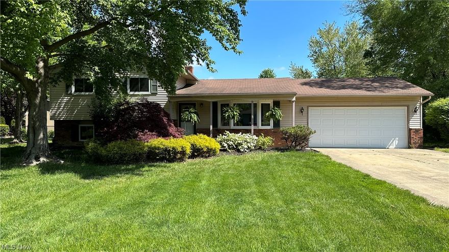 Welcome to your dream home in the highly desired Mentor Estates community! This spacious split-level boasts 3 bedrooms (plus a bedroom/office in the lower level), 1 1/2 baths, a family room and 2-car attached garage providing ample space for you & your loved ones to live, work & play. Step inside and be greeted by the spacious living room with large bay window that lets in an abundance of natural light. The formal dining room features a slider to the back patio and is adjacent to the eat-in kitchen. A perfect layout for hosting family gatherings & dinner parties. The upper level has three spacious bedrooms with hardwood floors. The master has two closets plus an additional space that can possibly be made into a posh beauty room. Updated modern full bath (2021). The lower level is perfect for relaxation &  recreation with a spacious family room, bedroom/office & laundry room with an exit to the back patio. Step outside to a fabulous 1/3 acre fenced-in backyard providing an abundance of