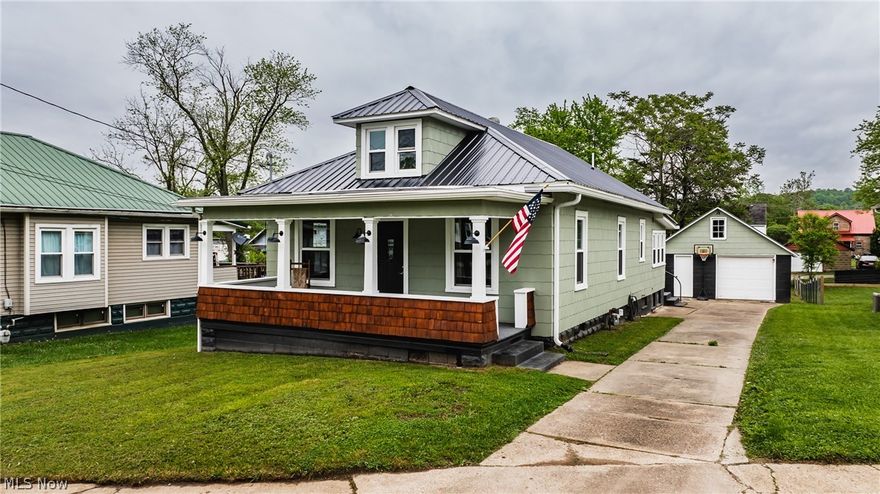 First floor living.  Two bedrooms on the main floor and one very large one in the 1/2 story.  You have an option for laundry.  First floor or in the lower level.  Kitchen and dining room is an open concept.  There is plenty of room to grow in the lower level.  Could be private for one or two people, or even a rental.  It has a private entrance.  There are so many updates you may want to see inside.  All above ground windows are new, and a double door with built in blinds.  New metal roof on the house, garage, and grilling patio!  Updated electric, and lighting, receptacles and switches.  New flooring and freshly painted throughout.  The furnace is new also.  Oversized garage with storage area above.  Situated on a nice flat lawn with alley access.