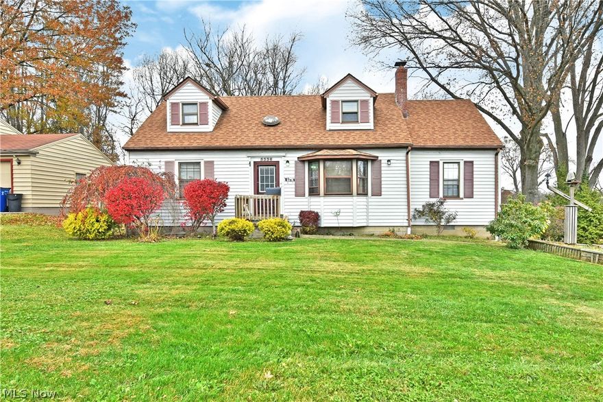 Move-in-ready and packed with charm, this lovely Austintown Cape Cod has all the right stuff in all the right places! Sitting picture perfect with its colorful landscaping and twin dormer windows that overlook the front yard, the beautiful home brings plenty of curb appeal. A concrete drive sweeps around back to reveal a sizeable, detached garage and a unique, partially covered rear patio with wrapping deck work and dual stairways. The park-like backyard even includes a covered swing with matching loveseats. Through the formal entry, a spacious carpeted living room elates with a bay window and sculpted entries that spill into the nearby kitchen and dining rooms; filled with rich, hardwood flooring. The central kitchen offers long countertops and a serving window into the posh, rear family room that offers patio access with its tiled landing and brick fireplace. A pair of inviting first-floor bedrooms that are nicely sized surround a casual full bath with stylish vanity and updated show