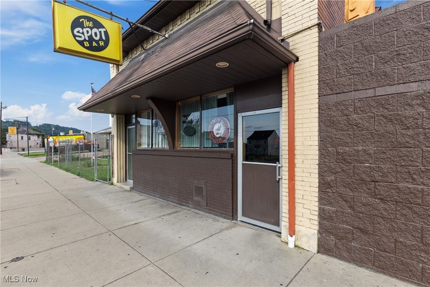 Don’t miss your chance to own The Spot Bar, an iconic Steubenville landmark and the centerpiece of the annual Dean Martin Festival. This legendary bar has been a local favorite for decades and is celebrated worldwide for its ties to Dean Martin, attracting fans and visitors year after year. The property spans five parcels and includes the main bar building, a second building for storage, and a large, fenced parking lot. Enjoy a spacious covered and open-air deck with its own secondary bar, ideal for outdoor events and live entertainment. An inviting garden area provides a relaxed gathering space for regulars and guests alike. The second level offers a 5 room apartment currently utilized as an office, providing additional potential for residential or rental income. This is a completely turnkey operation, sale includes all business-related chattels, furnishings, and stock on the premises at the time of transfer, ensuring a seamless transition for the new owner. Whether you continue its proud tradition or bring your own vision, this historic property offers unmatched character and opportunity. Own a living piece of entertainment history in Steubenville, Ohio!