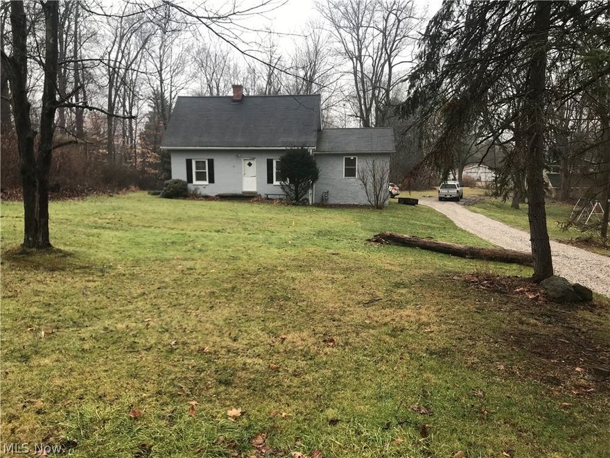 Enjoy the surrounding nature in this quaint cape code situated on over an acre which is  just a hop away from the metro parks trails and Cuy Valley National Park.  The updated kitchen offers plenty of cabinetry & is open to the dining area.   Gorgeous natural woodwork defines the living room adding to all its warmth.  First floor master suite has it's own walk-in closet along with the updated master bath.  An additional updated full bath w/skylight completes the first level.  Second level hosts 2 bedrooms with large closets and cubbies for storage.   Full basement with laundry and a ton of storage area with outdoor access makes it convenient for moving those "extras".    Detached 2 car garage and large outbuilding.  Own a piece of Sagamore's original charm !