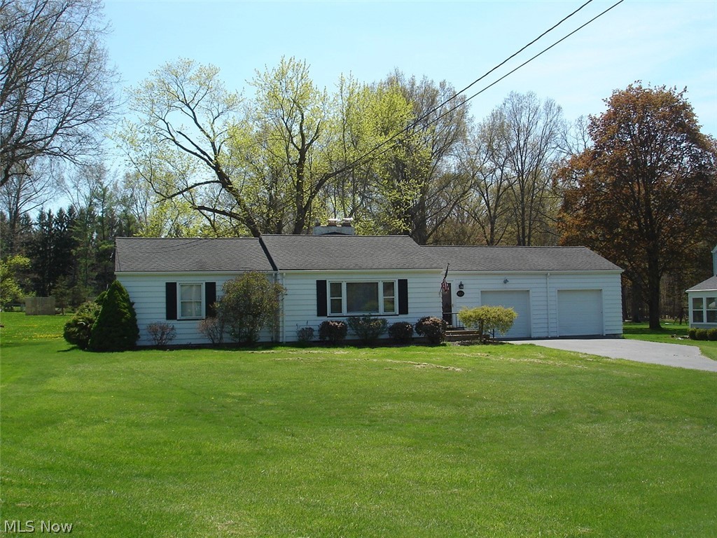 Aluminum sided ranch features large living room with fireplace, kitchen with eat in dinette and appliances. 2 large bed rooms with plenty of closet space. Hardwood floors throughout. Full basement with second fireplace and walkout from basement. Almost 3 car garage attached with opener. Covered patio that is 21x15. Large lot and much more.