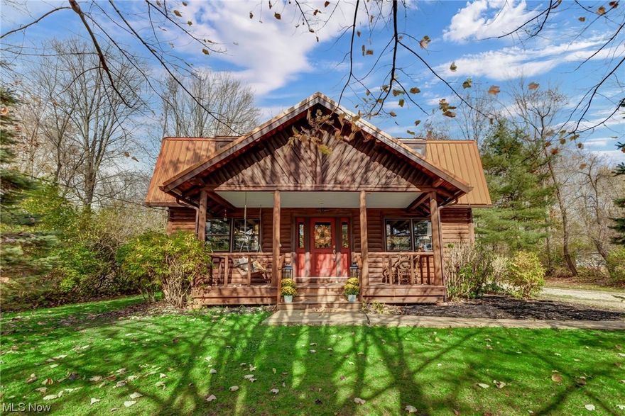 Nestled on over an acre of natural beauty, this charming log cabin home is the epitome of rustic elegance. Tastefully renovated to blend modern comforts with classic cabin aesthetics, it boasts three bedrooms, two and a half bathrooms, and a serene atmosphere that will make you feel like you're on a permanent retreat. The exterior showcases the timeless appeal of handcrafted logs. A spacious front porch welcomes you, providing the perfect spot to enjoy the tranquility of the surroundings. As you step inside, you're greeted by an open-concept living area, characterized by exposed wooden beams, and windows that flood the space with natural light. The kitchen is equipped with new stainless-steel appliances, granite countertops, and ample cabinetry. Off the Kitchen is the Great Room that  features a floor to ceiling stone fireplace and vaulted open beam ceilings. A dining area provides a great space for family meals and gatherings. A laundry room is conveniently located on the main level. The second floor is home to the master bedroom and two additional bedrooms. The property includes an expansive yard where you can enjoy outdoor activities. A detached garage provides space for two cars and extra storage. This  renovated log cabin home on over an acre is the perfect blend of comfort, rustic charm, and modern convenience, offering an escape from the hustle and bustle of everyday life. It's a place where you can relish the beauty of nature while enjoying all the comforts of home.