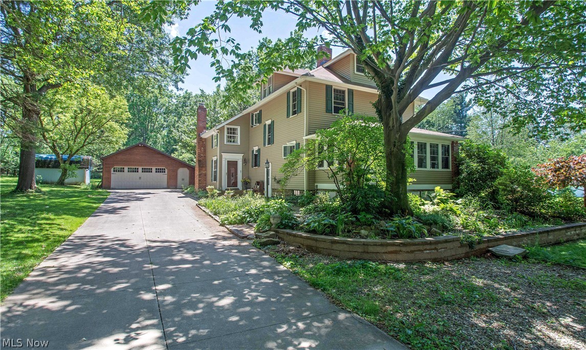 Welcome to this warm and inviting 4 bedroom, 2 bath colonial full of beauty, character and charm on a park like setting. The inviting front porch will make your family and guests feel right at home. The woodwork throughout is awesome! A freshly painted and updated kitchen with cherry cabinets offers newer appliances and ample counter space for meal preparation. Entertain easily with both a living room and fireplaced family room plus a formal dining room with gorgeous built-ins, hardwood floors & trayed ceiling. There are sliders off the family room to the lovely deck (there's even natural gas hookup for a grill available). The spacious master bedroom has been freshly painted, has great closet space, sitting area & connects to a full bath. The other 3 bedrooms are good sized also. Other updates include new roof (Aug 2017), waterproofed basement (approx. 2007); siding & front porch windows (2008); garage door (2016). The large workshop in the basement and a 4 car garage and wood
