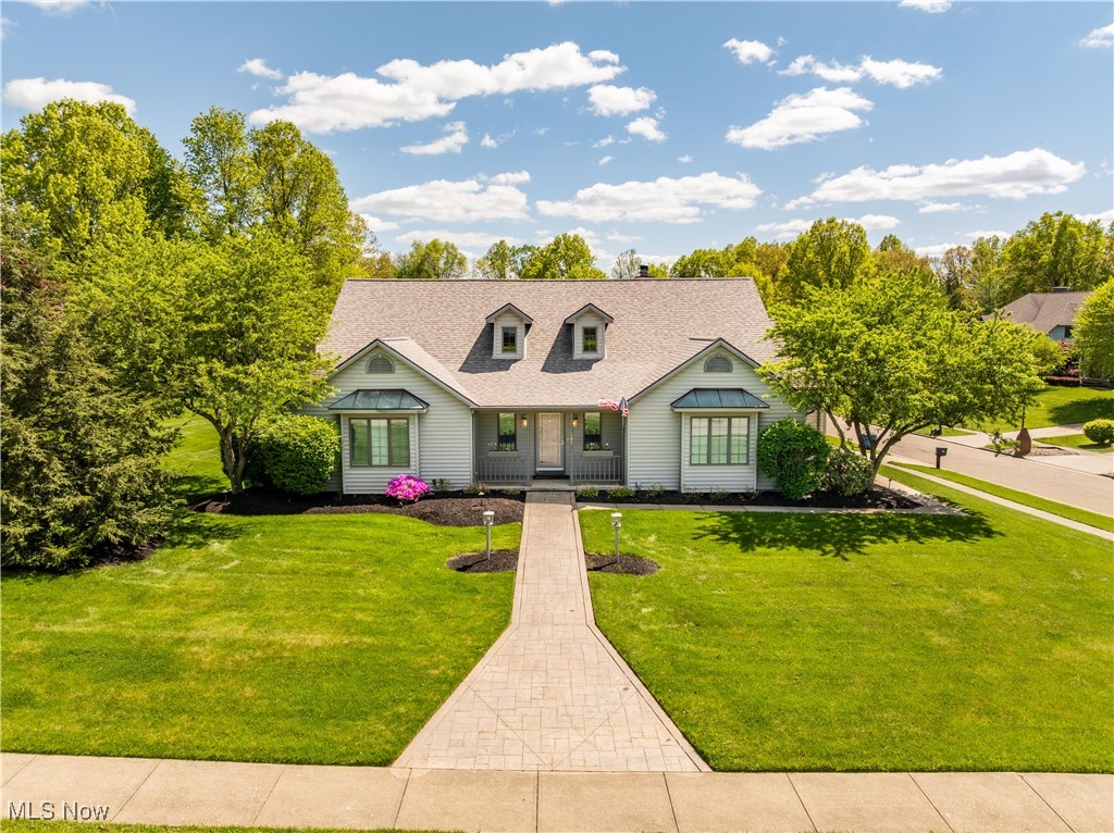 Welcome to your dream home in the prestigious Russo LaKhaki Woods subdivision, located in the award-winning Canfield Local School District. This executive-style property offers over 5,700 square feet of finished living space, blending comfort, functionality, and luxury in one of Canfield’s most desirable neighborhoods. The first-floor primary suite creates convenience and privacy, while the third floor features two additional bedrooms and a full bath, perfect for children, guests, or multigenerational living. The updated kitchen shines with quartz countertops, abundant storage, and easy access to the first-floor laundry—which could be relocated to the basement to create a spacious walk-in pantry. The main level showcases hardwood floors, vaulted ceilings, and an inviting sunroom currently used as a home office. Upstairs, brand-new carpet adds warmth and style. The finished basement expands your living and entertaining options with a full bar, a large recreation room, a media/playroom, and an additional bedroom, ideal for guests, teens, or a private in-law suite. Outdoors, enjoy a private patio surrounded by mature trees, offering a peaceful retreat or the perfect setting for gatherings. With its versatile floor plan, updated features, and sought-after location, this home is move-in ready and ideal for families, executives, and relocation buyers seeking both space and lifestyle