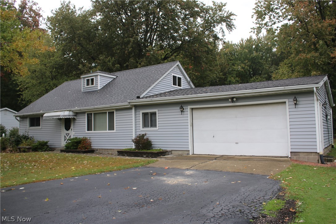 One owner home. Galley kitchen with custom made cabinets. Dining room, Large living room, Three bedrooms on the main floor, and two on second floor with half bath. Hardwood floors are original and in excellent condition. Newer roof, windows. large ticket items completed, just waiting for you personal updates and touch. 2 car attached garage that is a drive thru with rear door. Access to the second 2 car detached garage. In total 4 car oversized garages.. Perfect for car hobbiest, or personal use. This is a must see. Tons of storage throughout.