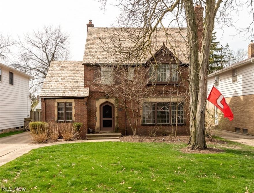 A gem of a home, from the "Moorish" inspired facade to the impressive family room addition, this three story colonial has a lot to offer. Entry foyer with patterned ceramic tile opens to an oversized living room with gorgeous hardwood flooring and wood burning fireplace. Elegant dining room is in "L" shape with living room for great entertaining flow. Updated kitchen with granite counters and white cabinetry and appliances is perfect for the home chef. Oversized family room with another wood burning fireplace, vaulted ceiling with fan, built-in bookcases, hardwood flooring, bay window to look out to the private back yard and French doors that open to the patio. First floor office and half bath complete the main floor. Upstairs Master suite has three large closets and updated en-suite full bath with step in stall shower. Two more bedrooms on second share a hall bath with convenient shower over tub. Finished wood paneled third level has huge space for either a master suite or home office plus a full bath. Lower level with rec room and laundry offers lots of storage space. Lovely back yard with detached garage has brick paver patio for summer evenings outside. New AC Spring 2023. Prime University Heights location close to John Carroll University, shopping and restaurants.