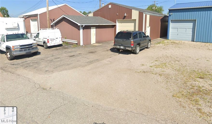 Garage/warehouse/office space (50x35 + 20x20). Heated with restroom. 10' and 14' drive in doors. Water & floor drains. Includes small lot (31x127) for parking or outside storage.