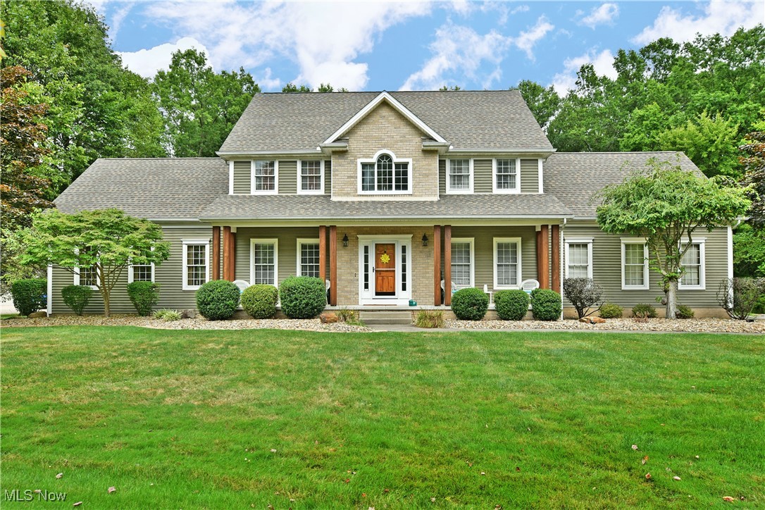 A visual masterclass in style, materials and more; this show stopping Canfield estate is set to take your breath away! Set deep within a highly desirable, private drive neighborhood, the expansive residence captivates from behind sculpted, rock bed landscaping to showcase its pillar lined and covered front porch. Arch topped windows grace the towering two story foyer as a cement drive wraps around to find a three-car garage. The stone walkway follows into an elaborate rear patio with tiered levels, inset grill and a lower chimenea where you can relax fireside at night. Step inside to find lavish woodwork and warm sunlight that filters through the tall windows. The carpeted staircase joins an immediate dining room as home office hides away opposite the foyer. Immerse yourself in the spacious living room where tall ceilings overlook the stone-lined fireplace. Overhead woodwork graces the must-see kitchen with its hooded Viking range, stone topped island, corner bar and onlooking sunroom-like lounge. Custom cabinets line the adjacent hall were an elegant half bath finds first floor laundry. Upstairs, don’t miss the oversized master suite, accompanying walk-in closet and remarkable full bath with dual vanities, jetted tub and tiled stall shower. Three additional bedrooms include both an attached bath and a common, full second-floor bath. The far bedroom enjoys its own walk-in closet with lounge. The finished basement is built to entertain with a central family room, full kitchen, half bath and dining; plus rec space and a home gym with additional storage available.