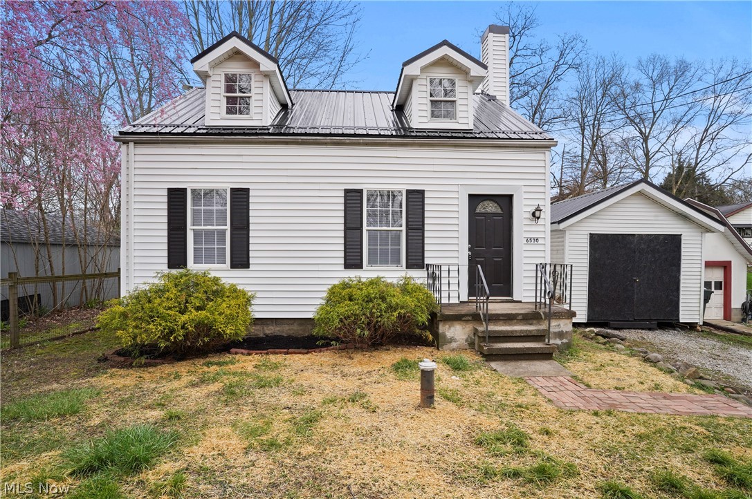 Welcome to this charming, updated Cape Cod home close to Brady Lake in Kent! Upon entering, you're greeted with sunlight streaming through the windows into the living space and onto the refinished hardwood floors. The adjacent kitchen showcases modern appliances, white shaker cabinets, and beautiful butcher block countertops. A full bathroom completes the main level, featuring contemporary fixtures and impressive subway tile. Upstairs you'll find two nicely sized bedrooms. The first bedroom boasts darling built-ins, large windows and hardwood floors. The second bedroom offers versatility, ideal for guests, a home office, or a cozy den. Venture downstairs to discover the partially finished basement, a versatile space. Whether utilized as a recreation room, home gym, or additional storage, this area adds valuable square footage to the home and adapts to your lifestyle needs. Other updates include: brand new black metal roof on the home and storage shed, as well as, a brand new electrical panel and updated plumbing throughout. This Cape Cod home combines modern amenities with classic charm, offering a comfortable and stylish retreat to call your own. Don't miss the opportunity to make this delightful property your new home!