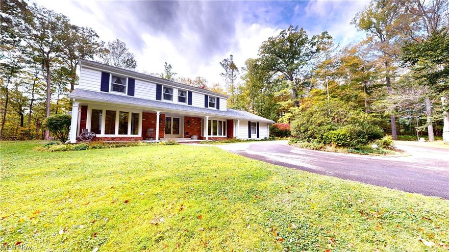 Well-Maintained Kirtland Hills Colonial on 5+Private Wooded Acres!  Tucked away with a private/shared drive, this nature lovers dream is surrounded by woods and a natural ravine.  Inside the wide-open, two-story foyer offers a gorgeous, curved staircase and hardwood floors.   With tons of charm and solid wood doors throughout, the formal living room features a gas fireplace, crown moldings and leads to the office with French doors and built-in bookshelves.  The family room offers a wood burning fireplace, 3 sets of built-in bookshelves. and sliders to the deck.  The roomy eat-in kitchen has tons of counter space, a new range hood and all appliances stay.  The light-and-bright formal dining room with a huge, bow window, a cozy powder room and laundry with a door leading outside complete the first floor.  The second floor offers 3 large bedrooms with ample closets, a full hall bath and an owners ensuite with a functional split bath and closet.  The lower level walk-out offers so many possibilities with a large rec space that can converted into a legal 5th bedroom or a second office, a workshop and storage area.  A two-car garage,  two-tiered deck overlooking a deep wooded back yard and shed complete this lovely home.  More recent big-ticket updates include: Rebuilt walk-out retaining wall (2023), AC (2023), Roof (2020) Gutters/leaf guard (2020), and many rooms have been freshly painted (2024) .  Located in idyllic Kirtland Hills, close to I-90 and 30 minutes from downtown CLE.  Also located within the highest ranked school district in Lake County per several sources.   Check out the 3D tour and call for your showing today!