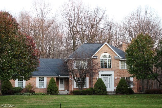 Charming, well built brick 2 story on private 1.3 acre treed lot bordering golf course* Offering 3 bedrooms, 2.5 baths, 2990SF plus 490SF in finished lower level & 3 car generous side load garage* Entry with oak floor & open to formal dining with oak floor & living room both with crown molding* Step down family room with brick fireplace, French doors to living room & window wall with double Andersen slider to brick walled stone patio* Pillars accent entry to spacious eat in kitchen with center island breakfast bar, vegetable sink, walk in pantry, desk, & ceramic tile floor* Kitchen/eating area is open to the 4 season vaulted sun room wrapped with windows, ceramic floor & access to stone patio* 1st floor laundry with folding table, cupboards, closet & utility sink* Master suite sitting room with huge Palladium window & built in bookshelves overlooking foyer, large walk in plus additional closet* Glamour bath with jetted tub, separate shower, double vanity & sky light* Lower level rec ro