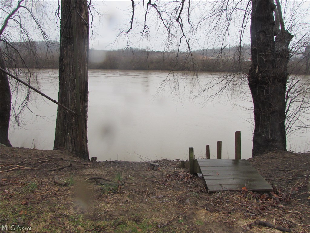 If your looking for a great weekend get-a-way this might be it. Offering 4.12 acres with river frontage and camp sites for RV's. If your interested you better come and check this one out. There is a old building with newer addition added on to it plus a separate pump house. There is well water and public water available. Access off of highway.