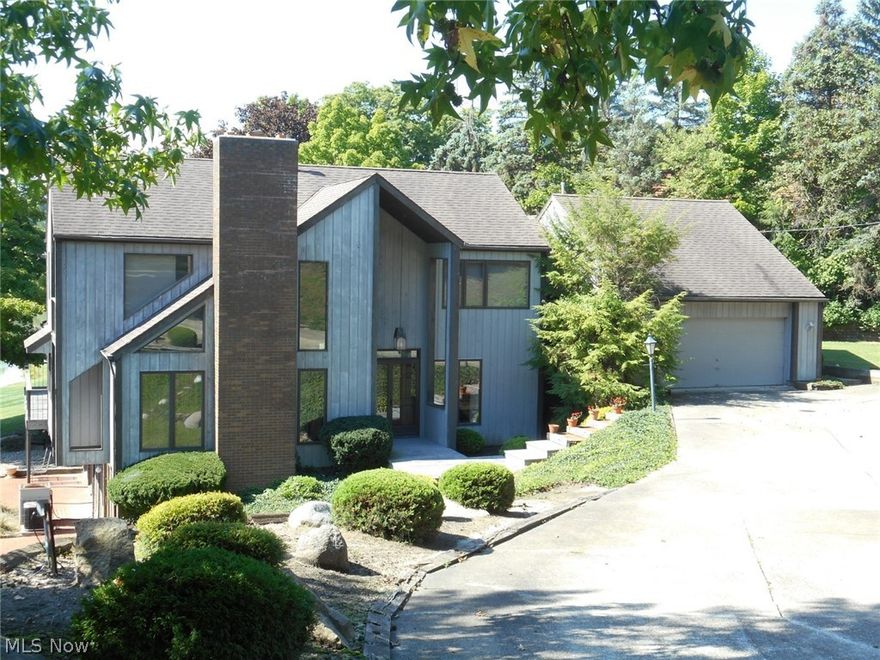 Lakefront custom built contemporary is situated on a gorgeous lot with awesome views of Lake Roger & Lake Martin. An abundance of windows and sliding doors allow for easy enjoyment of all 4 seasons.  This beautiful home features a wonderful open floor plan.  The family room and vaulted living room offer fireplaces to help warm those cool evenings.  Stunning hardwood floors accent the family room, sitting room, dining room, and living room.  The spacious 3 season room with skylights and woodburning stove is an added bonus with sliders that lead to the patio overlooking Lake Martin.  A laundry room, 2 half baths, office and mud room complete the first level of this home.  On the second floor you’ll find a loft (perfect for office space with built-ins and sliders to a deck overlooking Lake Roger) plus 4 spacious bedrooms with nice closet space and 2 full baths.  The master suite offers an 8 x 10 walk-in closet plus 3 other closets, built-ins and a huge master bath with double vanities, so