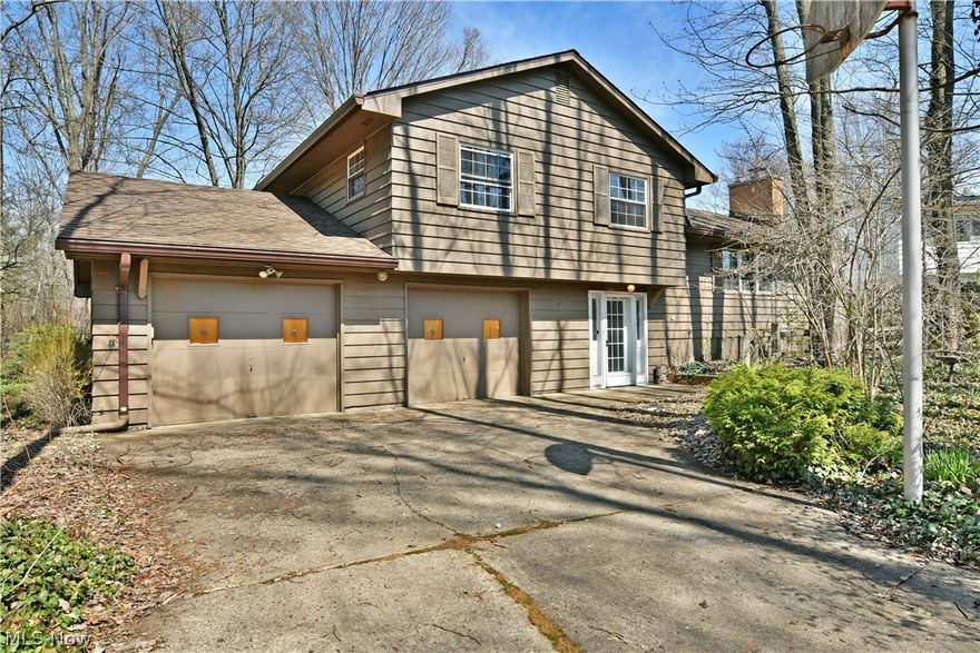 Potential like no other, this intriguing Howland home is a literal hidden gem, tucked away in a must-see wooded lot that must be seen to appreciate! If you enjoy your privacy and scenic, woodland views, this spacious, split-level should be high on your list. Whether you’re looking for move-in-ready or a fantastic platform to expand your creativity, the impressive three-bedroom layout is sure to please, offering four levels to include a sizeable basement where storage, utilities and laundry service is found. Located off a quiet side street, the residence sits far back in a tree-lined lot, blending into nature with its earth-toned exterior. The cement driveway leads up to a two-car attached garage, while around the back, a brick patio extends towards the trees. Step inside the decorative front door to find the carpeted lower level and family room where sliding doors open to the backyard. Up the stairs, an outstretched living room finds a brick trimmed fireplace along the far wall and lattice lined windows that introduce plenty of sunshine. Around the corner, the elegantly lit dining area also provides an exit to a raised rear deck. The handsome kitchen includes its own casual dining nook along with wood-faced cabinetry. At the third level, a cozy full bath is first at the hallway, with the trio of inviting bedrooms to follow, branching away with their combined hard wood and carpeted flooring. An oversized master bedroom includes dual closets and its own full private bath. There are two parcels totaling .547 acres. The potential is endless.