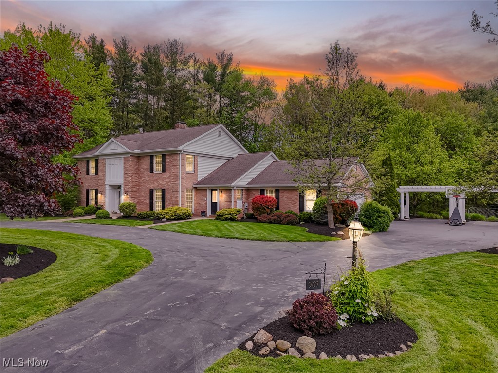 This impressive 7-bedroom center hall colonial offers over 4,400 sq ft of above-grade living, set on a private 1.36-acre lot in sought-after Bath Township. Thoughtfully designed, this home features beautifully refinished hardwood floors across most of the main level, three fireplaces, a main-floor primary suite with a private sitting room, and a stunning library with custom built-ins and fireplace. Upstairs, you will find four additional bedrooms, including a second primary suite—ideal for multi-generational living or guests. The walk-out lower level adds 1,800+ sq ft of finished space including a 2-bedroom, full bath in-law suite and direct access to a secluded patio. The large yard feels like a private retreat, surrounded by mature trees and established landscaping. Parking and storage are abundant, with an attached, heated two-car garage and a separate heated, two-car garage that includes a large, unfinished upper level—perfect for a home office, studio, or future expansion. A rare blend of size, versatility, and timeless charm in one of the area’s most desirable locations! In the Revere School District!