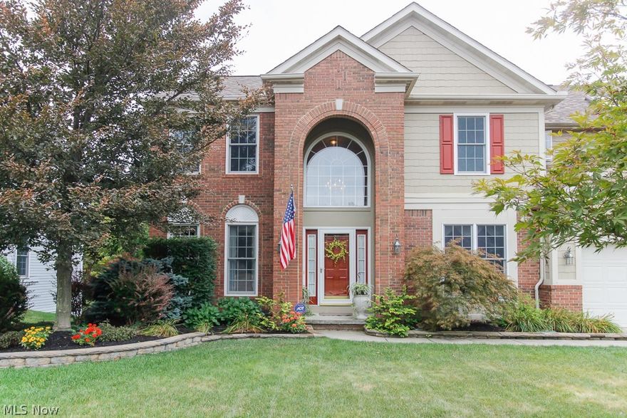 Brick front colonial on impressively landscaped lot with walk-out basement.  This stunning home offers 9’ ceilings, deluxe crown moldings & ceiling fans throughout.  Offering an open & airy kitchen designed in 2014 is perfect for entertaining with a 9’ center island, solid surface counters, tile backsplash, cherry cabinets, wine bar, wine refrigerator & maple hardwood floors that run throughout the kitchen, dinette and dining room. The dinette off the kitchen has vaulted ceilings, 4 oversized windows & a sliding door that leads you onto a large deck with a scenic view of the surrounding woods & nature. Step back inside to your family room with cozy gas fireplace & bay window. A walk-out finished 13-course basement with French doors lead you unto a newly stamped patio & custom-designed attached storage area. A Large master bedroom with vaulted ceiling includes a private bath with large dual shower, rain shower head, dual sinks, heated ceramic tile flooring & walk-in closet.  Other featu