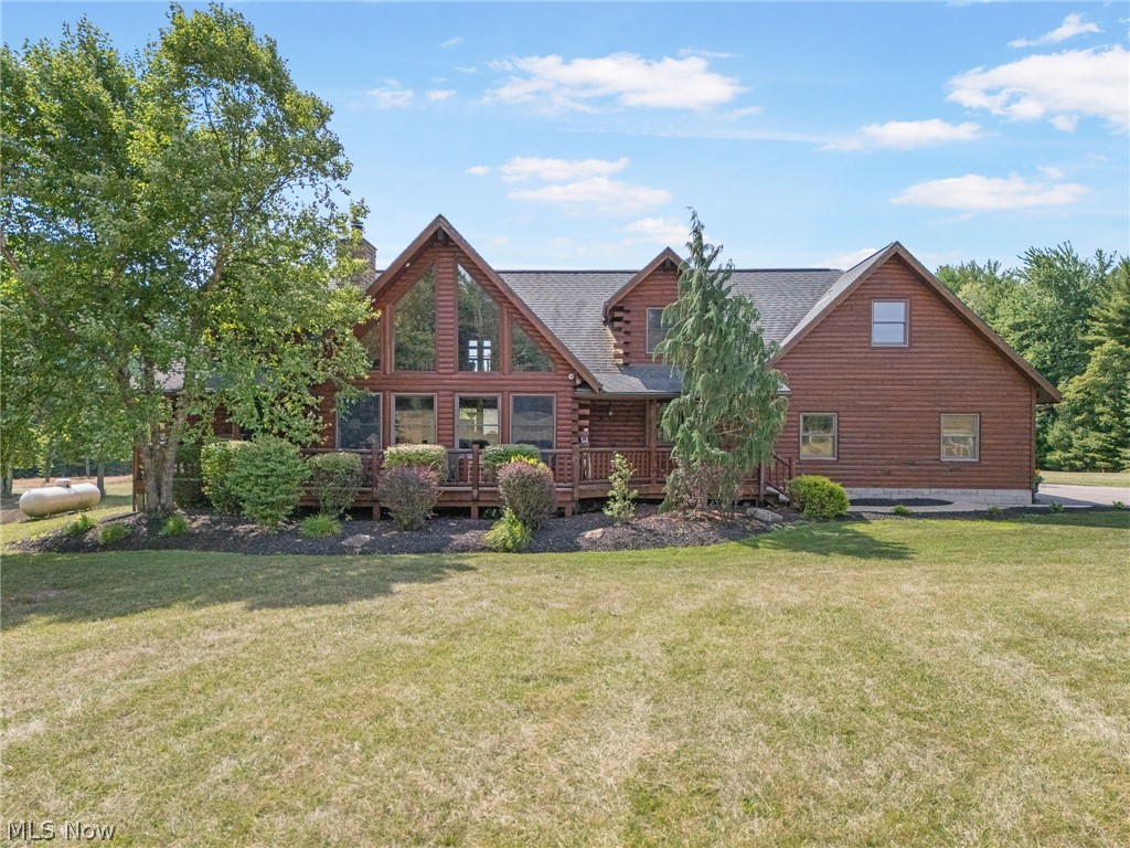 **STUNNING LOG HOME Secluded on 12 Acres in Dover, OH **
Welcome to 8269 Everhart Rd. NE, Dover. This beautiful log home built in 2009, is nestled on 12 picturesque acres in the Tusky Valley school district. This dream home features 4 bedrooms, with the master suite conveniently located on the first floor complete with a full bath and a walk-in closet. As you enter this home on the main floor you will find a half bath and a laundry room, leading to an open-concept living space. Featuring a kitchen with appliances, living room with a stunning stone fireplace , a dining room with cathedral ceilings, office space and a captivating half-log staircase. The second floor offers 3 additional bedrooms, a cozy loft, and a game room that is perfect for family fun.
The home also boasts a 13-course high basement with ample space and direct access to the attached 3-car garage. Enjoy your morning coffee or evening sunsets on the peaceful covered porch at the front of the home. The property includes the beginnings of a pond, making it a serene and beautiful place to call home. Adding to its charm and efficiency, this home is equipped with solar panels, an outdoor wood burner, and a backup propane furnace with radiant floor heat. You do not want to miss out on this incredible opportunity for your own personal retreat. This home is priced to sell at $675,000, and will not last long.