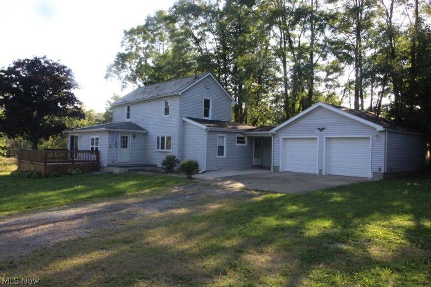 Situated on 1.5 acres this 2 story vinyl sided century home has been remodeled and updated with a brand new kitchen.  First floor features include a convenient utility room, dining room, living room with French doors which lead to an enclosed sun room.  There are 2 full baths and 2 spacious bedrooms on the first floor.  An additional bedroom is upstairs with 2 bonus rooms and a half bath.  There is a partial basement, an attached 2 car garage, deck and an extra outbuilding. On the additional lot is a 32 x 24  pole garage with concrete floor. All situated on 2 lots on the outskirts of town.