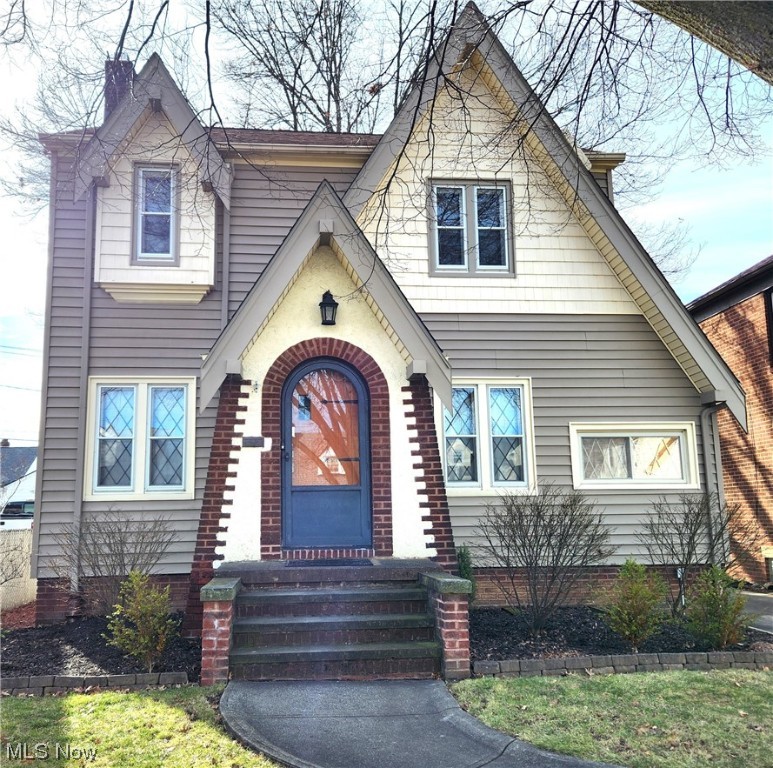 This charming Tudor not only offers curb appeal with brick/updated siding, a curved entry, and diamond-leaded windows in front (with new storms)--it features the original, pristine built-ins, mantel, and interior doors with hardware. This 3-bedroom, 1.5-bath home includes a lovely sunroom to visit with friends; an upstairs, enclosed porch for morning coffee and a good book; and walk-up attic for convenient storage or to add your finishing touches for a bonus room! Enjoy cooking in the custom kitchen, remodeled in 2022, that encompasses quartz counters, beautiful neutral backsplash and hood vent, farmhouse sink, coffee bar, display case cabinetry, ample storage cabinetry, soft-close hardware, stainless appliances, and a fandalier with other matching lighting. Other updates include a remodeled full bathroom (2022), windows throughout, insulation, interior drains, electrical panel, and HVAC. A new roof was installed on the home and garage in 2022! Out back, enjoy summer evenings on the patio with detailed landscaping! The garage is well insulated and includes attic storage. Two sheds are included with the property. This home offers easy access to the freeway and close to shopping and restaurants.