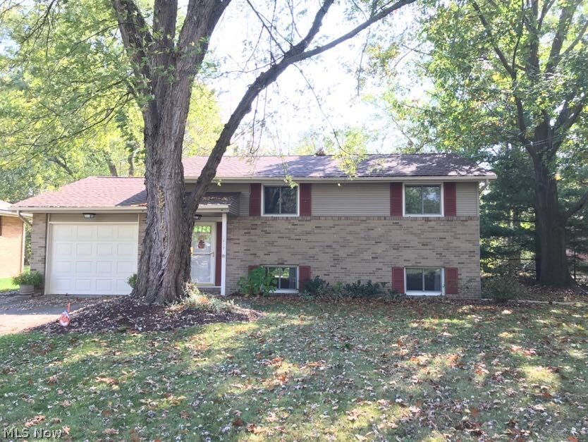 Serenity describes this well-cared-for vinyl-sided bi-level haven... within reach of all life's conveniences yet tucked in alongside woods and the Cuyahoga River! Close to shopping, hikeNbike trail at Middlebury/261, Fred Fuller Park, & certainly within walking distance of downtown Kent and a short drive to KSU! BEAUTIFUL & expansive park-like back yard with a sloped buffer of thicket and trees down to the river. Renewal by Anderson windows installed in 2010, Original Hardwood floors in living room and All bedrooms. Newer Garage and Screen/Storm Doors throughout. Newer washer/dryer included and electric panel & oven/range replaced in 2012. New roof and covered gutters installed in 2014. All of this plus a 1-year home warranty for the lucky buyer! Say YES to serenity... a beautiful house to call HOME. Wonderful location and nicely cared for. Put your own style throughout and make it yours today!