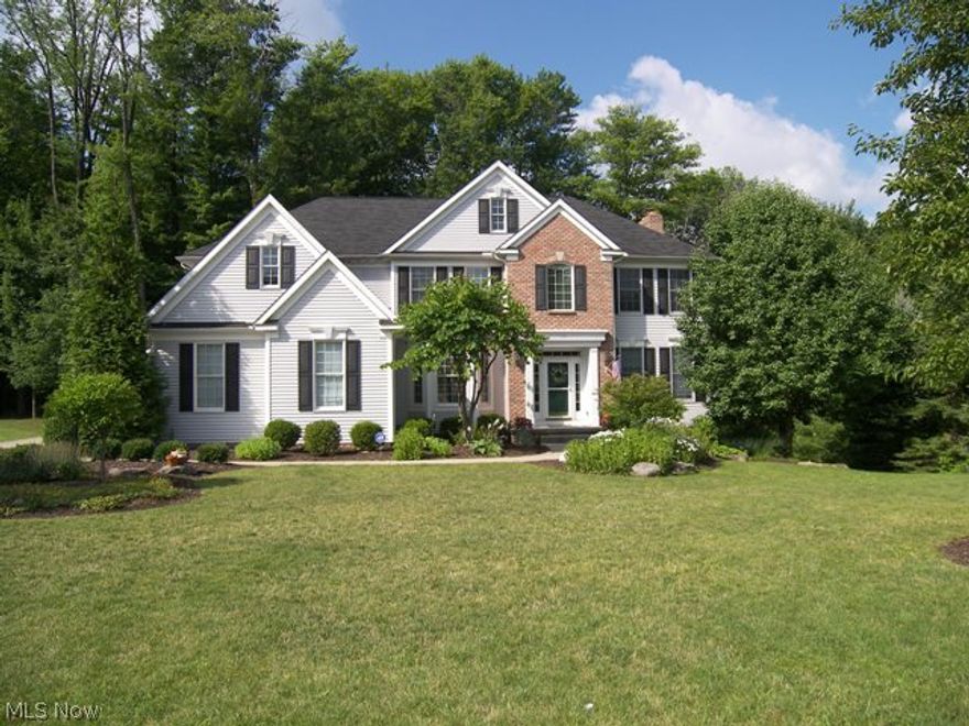 Welcome Home!  Beautiful transitional built by Prestige Homes with a 3 car garage situated on a private cul de sac setting backing up to a wooded area with a fenced backyard.  The gracious foyer with wood flooring opens to the living room/den with French doors and the formal dining room.  This open floor plan features a two story great room with a stone front fireplace and walls of windows and opens to the spacious kitchen with cherry cabinets, Corian countertops, wood flooring, a center island and appliances.  There is an atrium door from the eating area to the deck and backyard.  All bedrooms are on the second floor with three full baths with the master suite featuring a large walk in closet and glamour bath with double sinks.  The other bedrooms are generous in size all with bath access and one being a suite. Not to be missed is the finished walkout lower level with a recreation room, full bath and another finished room.  There are doors to the patio and backyard.  This is a wonderf