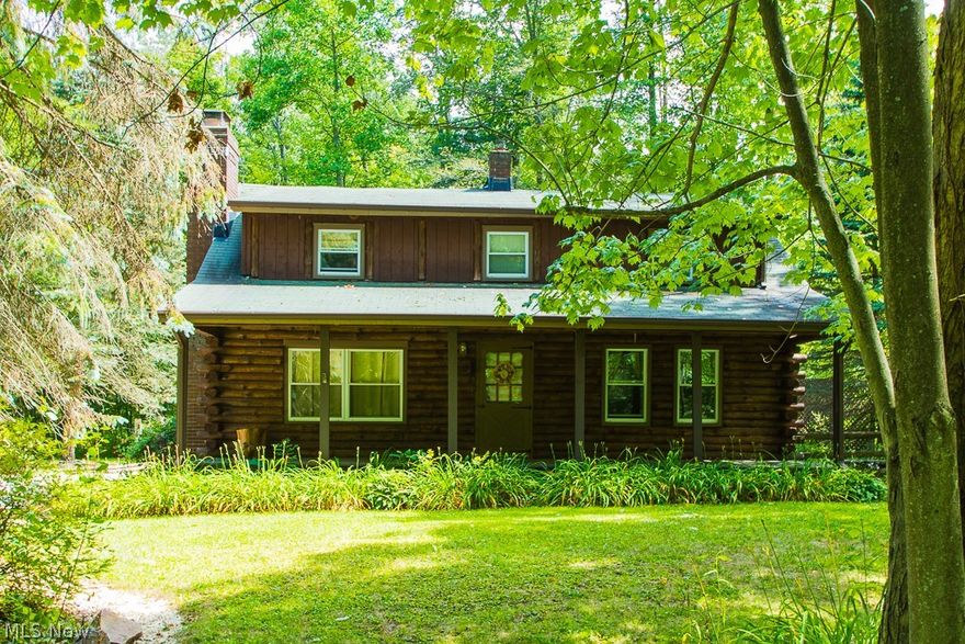 This Awesome Log Home sits on 3.5 wooded acres for a true nature lover's retreat.  The detached 2+ car garage has a 30x10 workshop.  There are tons of outdoor living spaces to take advantage of with a beautiful covered front porch and a screened back porch that leads out onto a large wood deck.  Set back and secluded for privacy.  The interior will not disappoint with its cozy log beam construction, and field stone fire place.