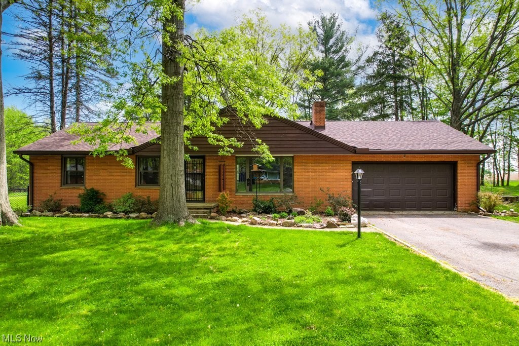 Welcome to this well-maintained and rare all-brick ranch home in Stow, Ohio! This unique 3BD/1.5BA home is nestled on a quiet, tree-lined street with close proximity to all of Stow's local amenities, shopping, dining, and entertainment options. One of the most extraordinary features of this home is the large fully fenced backyard, which backs up to the flight path for KSU Airport, guaranteeing that you will not have to worry about new construction in your backyard! Upon entering the home, you'll notice the stylish vinyl plank flooring (2023) that flows seamlessly throughout the entire home, and the spacious and open living room features a cozy wood burning fireplace. The home also boasts an array of significant upgrades, including a complete roof tear-off (2023), HVAC and electrical panel (2016), a majority of replacement windows (2017), and hot water tank (2015) - all of which provide improved energy efficiency, enhanced comfort, and natural light throughout the space. In addition, th