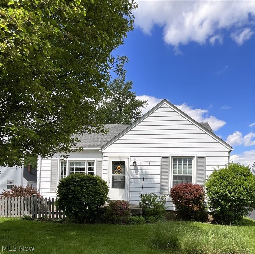 Charming Cape Cod home featuring 3 bedrooms and 1.5 baths. The living room offers a cozy fireplace, while the dining room includes a built-in corner cabinet for added character. Ans the family room provides extra living space. The main floor showcases original hardwood floors, and kitchen appliances are included. Replacement windows and a seller providing a one year home warranty add comfort and efficiency. Selling as-is.