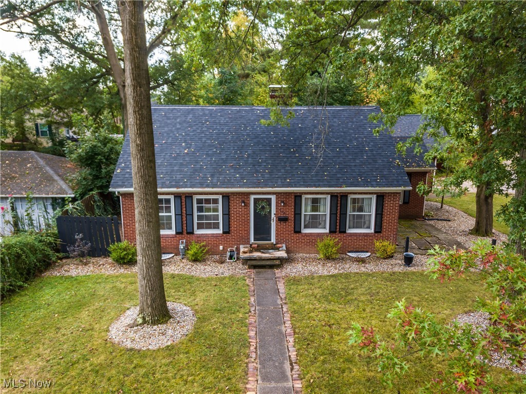 Welcome home to this charming brick bungalow in the heart of Alliance. As you make your way inside, you will find two bedrooms on the main floor with a oversized third bedroom that can also be used as an office or as an additional room for storage. One full bath is on the main living area with a half bath downstairs. This home has two fireplaces, one being in the main living room that connects to the kitchen and dining room. Downstairs features an additional family room with that second fireplace as well as a relaxing hangout spot with a full bar area that's perfect for game nights or just relaxing after a long day. Outside, the fenced in back yard also features a spacious deck and connects to the two car garage. This home is move in ready and just needs you to make it yours. Call to schedule your private showing today !