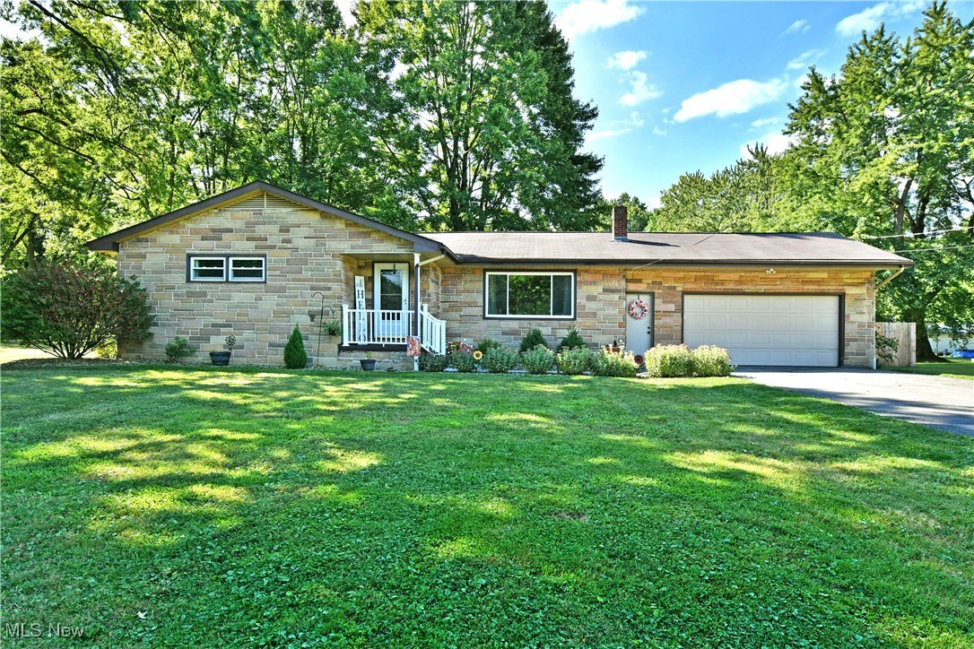 Immerse yourself in the engaging country styling and warm, inviting surroundings found within this gorgeous Vienna home! Showcasing a desirable, three-bedroom ranch layout with a full basement, this residence should be high on anyone’s wish list. Instantly captivating with its handsome stonework and manicured landscaping, the attraction piles on to reveal an expansive, privacy fence lined backyard; perfect for soaking up that late summer sunshine. A covered corner entrance leads you inside as the sunken foyer opens to a spacious living room, awash in natural light as hardwood flooring runs underfoot. The whitewashed accent wall brings a touch of rustic style while the nearby dining area includes available bar-top seating and sliding doors that lead out onto the rear deck. Brightly lit with its sweeping tiled backsplash, the kitchen delights with its faux wood countertops and durable tiled flooring that accents the stainless-steel appliances. Down the main hall, a tastefully updated full bath mimics the kitchen tile work for added style. Three gracious bedrooms bring colorful appointments and large closets as the hardwoods continue throughout each room. Plenty of storage is available at the basement level along with utility access, corner rec space, storage and provisions for a full lower bath that includes a stall shower.