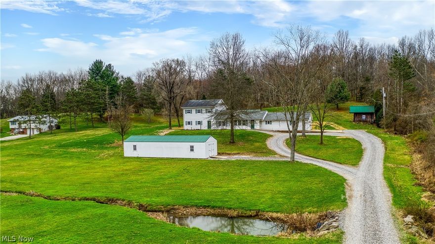 Discover the charm and spaciousness of this Classic American Colonial home situated on an expansive 4.8-acre lot. Boasting 5 bedrooms and 2 bathrooms, this property offers ample space and versatility for comfortable living.

The main floor features a generously sized bedroom, ideal for a master suite or guest room, along with a full bathroom nearby. The remaining bedrooms are located upstairs, providing privacy and convenience.

The heart of the home is the large family room, perfect for gatherings and relaxation. The large kitchen has a breakfast bar and is perfect for entertaining.

Outside, the property is a nature lover's paradise, with a creek running through the front attracting visits from native wildlife regularly. A long circle driveway leads to the welcoming front entrance, while a large 2-car garage and additional storage sheds one being 48' x 16' to provide ample space for vehicles and outdoor equipment.

Enjoy the outdoors in the custom pavilion with a concrete floor, ideal for hosting gatherings and enjoying the peaceful surroundings.

This property offers the perfect blend of rural tranquility and modern amenities. Don't miss the opportunity to make it your own. Schedule a showing today!