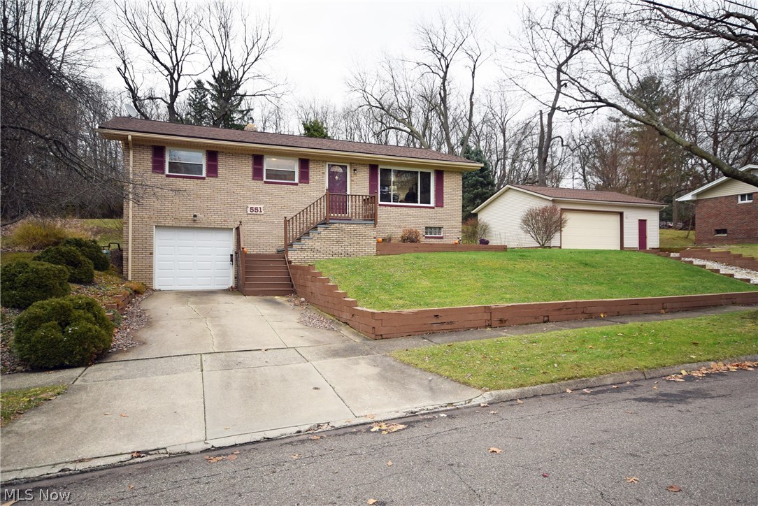 Updated brick ranch! Spacious living room with gas log fireplace, 3 bedroom, 1.5 bathroom, 3 car garage, one attached and 2 car detached with a separate driveway to the detached garage, perfect for car collector, mechanic, boat, camper, etc. Finished family room in lower level with unfinished laundry/utility/storage room. Many updates including: tiled bathroom shower(2014), roof(2012), windows(2014), detached garage built(2001), hot water heater(2010), new carpet, new overhead garage door & opener on attached garage (2016). No worries as this home comes with a 1 year America's Preferred Home Warranty. Great find with all the garage space with city utilities. Don't wait 'til it's sold, call today to schedule your personal tour.