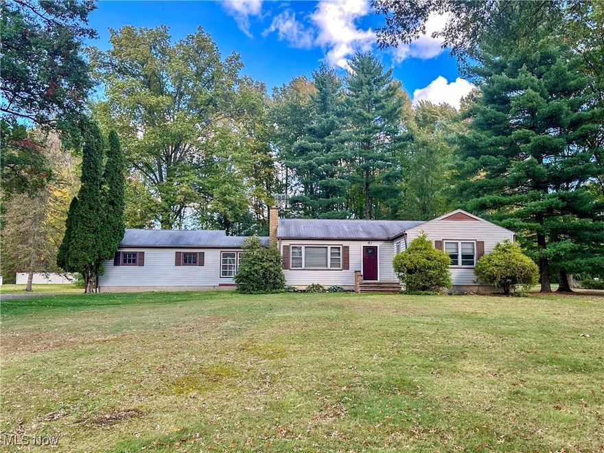 Discover the perfect blend of classic charm and modern convenience in this wonderful 3-bedroom, 1-bath ranch-style home, perfectly nestled on a generous 1.01-acre corner lot in an idyllic Howland neighborhood. This property offers an abundance of outdoor space featuring mature trees and a sprawling grassy area, perfect for summer barbecues, backyard baseball games or planting a garden. Step inside to find a spacious living room adorned with a woodburning fireplace, creating a warm and inviting atmosphere for relaxation. The nicely updated kitchen, complete with a large dining area, is designed for both cooking and entertaining, making it the heart of the home. The primary bedroom boasts a built-in desk/vanity with storage and dual closets, providing both functionality and style. Two additional bedrooms and an updated bathroom with a walk-in shower round out the comfortable living space. Notice the beautiful hardwood floors and arched doorways found throughout the main floor, which add to its timeless charm and appeal. The full basement presents a blank canvas, ready for your personal touch—whether you envision a recreation room, home office or playroom, the possibilities are endless. This versatile space also includes a large laundry room, workshop area and plenty of storage options to keep your home organized. A newer well pump (2023) and furnace (2019) ensure comfort and efficiency. A convenient breezeway connects the two-car garage to the house so you stay sheltered from the elements while coming and going. Additional features include a carport and a large shed for extra storage needs. Step into the backyard where a charming patio awaits, perfect for outdoor dining or relaxing after a long day. Best of all, this home is located in the coveted Howland school district and close to amenities like shopping, dining and recreation. This tucked-away treasure is not just a place to live; it's a place to grow and thrive. Don’t miss the opportunity to make it your own!