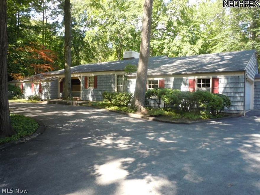 This spacious 3,038 sq ft, Four/five bedroom, 5 full bath ranch has cedar shake siding.  Private setting on a dead end street, decks overlooking wooded ravine with creek, 5 garages have approximately 9 vehicle capacity, walk out basement, security system.  A paneled den 13x17, could be used as 4th bedroom on 1st floor, a 10x13 Fifth bedroom is in basement, 196x203 lot is .9134 acres, 2 gas F/A furnaces.