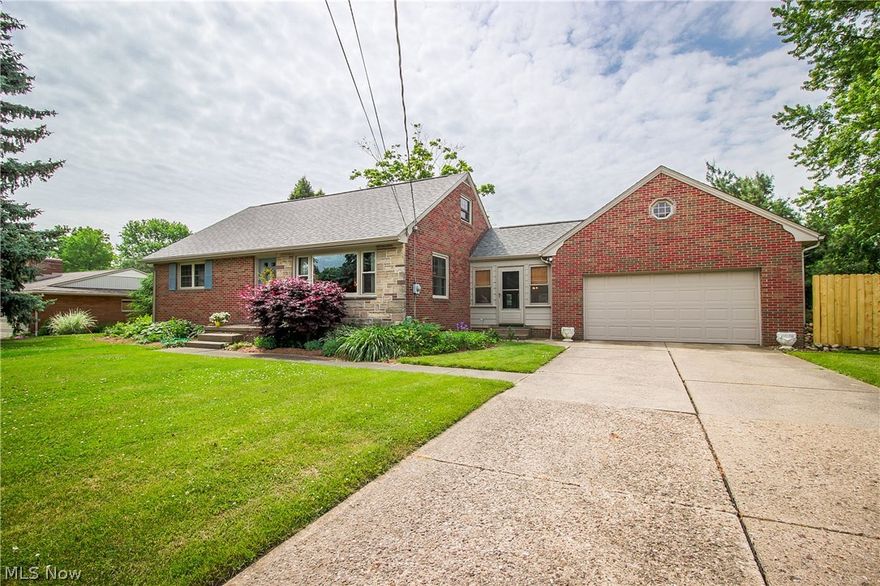 This home is immaculate and definitely not your typical bungalow!  Enter into the living room with neutral paint, newer windows and original hardwood flooring that runs throughout the home.  The spacious kitchen can accommodate a large dining table plus has bright white cabinets, stainless appliances, tiled backsplash and newer Pergo laminate flooring!  A breezeway connects the 2 car garage to the home and also leads to a large sun room with wood burning fireplace.  Two of the bedrooms are on the main level including the master which has two double closets.  An updated full bath with newer laminate flooring, counter and shower surround completes the main level.  Upstairs you'll find two more generously sized bedrooms that share a half bath.  The lower level has two finished rooms that would be great as a rec room or craft room plus there's a shower stall, additional space for storage and a fruit cellar.  Situated on over half an acre, there's even more to love outside!  A flagstone pat
