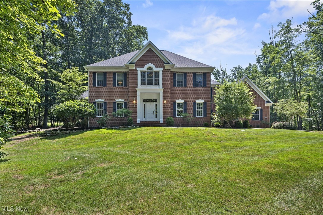 Gorgeous Custom built 5-bedroom gracious Colonial, sitting on a little over 3 wooded acres on Ledgeview Drive in the "Ledges" of Peninsula, OH. This home is designed for both comfort and sophistication.
Enter through the front door and find a spacious foyer and warm beautiful hardwood flooring that draws you into the heart of the home and compliments the beautiful staircase. The chef's kitchen includes granite countertops, custom cabinets with pullouts, an island/bar, newer appliances. The kitchen over looks the vaulted eating area with a wall of windows over looking the spectacular private back yard, extensive patio & firepit area. The kitchen flows into and overlooks the spacious family room with gas fireplace, built ins and a wall of windows over looking the landscaped/wooded backyard.
This home offers wonderful natural light year round.
The first floor office/library features built-ins and a closet. This room has the option to also be used as a first floor bedroom.
The classic 4 Seasons room w/chandelier lighting has access to the backyard patio and private side yard views.
The seperate spacious first floor laundry room and mud rooms are located just off of the kitchen and 3 car garage.
The second story owner's suite is complemented by a bonus/sitting area, spa-like bathroom with double sink, jetted/soaking tub and shower room. There are 4 additional bedrooms, 1 bedroom w/full private bathroom & 2 adjoining bedrooms w/jack & jill bathrooom. The 5th bedroom presently used as a second floor office to complete this upper level.
Heading to the full finished lower level that offers a bar area, hobby room, workout room and full bath for family entertainment. This basement has plenty of additional space for storage and a workshop if needed.
Once out side you have an extensive paver patio for enjoying spring, summer & fall seasons and do not miss the firepit area.
You will not be disappointed with this property and home.