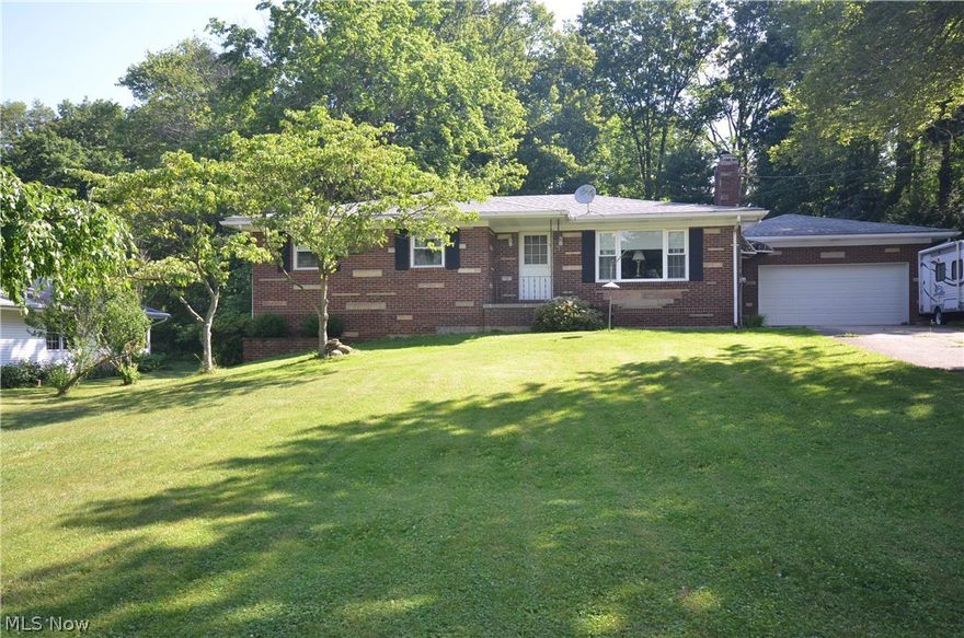 Quality built all brick home on rare .7 acre lot backing up to a wooded land-locked parcel 1 Block from Metro Parks Bike & Hike Trail! Tons of updates & absolute move in condition. Liv rm w big picture window & decorative stone fireplace w mantel open to the dining rm w beautiful hardwood floors & built in china cabinet.  Lg storage closet w pantry shelving. Kitchen w tile backsplash, built in shelving & ceiling fan. All bedrooms offer hardwood floors- including a master bedroom w dual closets & private ½ bath. Full bth w makeup vanity, shower/tub & built in storage. Tons of hall storage in big closets- plus an attic fan to drastically lower cooling bills!  Basement rec rm w high quality Buck Wood Burning Stove insert w mantel. Spacious laundry area w 2 basin utility sink, basement bathroom includes a shower & commode w sink. Back yard includes brick patio, wonderful landscape w wild W Virginia Holly Trees & hand-planted evergreens, active garden, 2 grape arbors, & hand built river roc