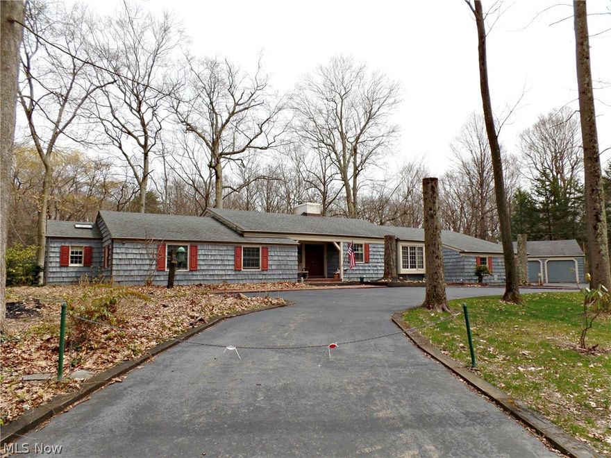 Peaceful wooded ravine parklike setting is home to this sprawling Ranch style home.  This one of a kind home was custom built and has beautiful craftsmanship and charm throughout.  Enter the property through the grand circular driveway that leads to a covered front porch, and into a tiled foyer.  Spacious living room with fireplace, built ins and stunning wooded views.  Formal dining room also has native views, and sliding glass doors to the tiered deck.  Eat in kitchen, appliances are negotiable- laundry can be 1st floor off of kitchen, or in lower level.  5 bedrooms including the maser suit with breathtaking views and his and hers closets and bathroom.  Full walk out lower level also has stunning views from the family room and 2nd kitchen.  Another gem of this property is the 7-car attached garage- with heat and a/c for a deluxe man cave!  A home warranty is included for a worry-free purchase!  Call today to schedule a private tour!
