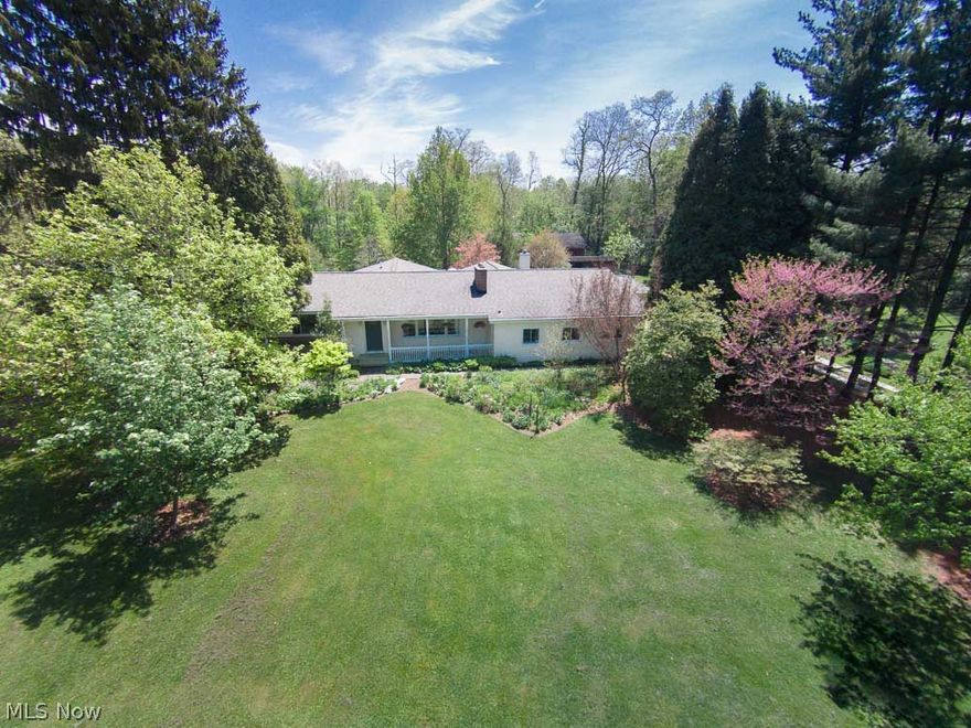 Set back from the road, this well maintained ranch is a RARE FIND!!  Truly unique, property is a certified wildlife habitat with over 300 plant varieties designed and maintained by a local horticulture professional.  Enjoy the views of gardens, birds and butterflies from the sun room/morning room with walls of windows. Updated kitchen boasts customized ceramic tile, apron front farm sink from France, granite counter tops, breakfast bar, leaded glass front cabinets, oven, and antique looking range from Elmira Stove Works with convection oven. Other features include red oak hardwood floors, a solarium/conservatory, gas fireplace, wood fireplace, library with 12 ft world map, recessed lighting, bonus room/in-law suite, jetted jacuzzi tub, 3 zone heating/cooling, new gravel drive, oversized garage, 14x20 shed, covered screened in patio, and a 24x32 pole barn, too much to list!  Unassuming frontage leads to a nature lovers private paradise behind. 1 year home warranty included!! Don't miss