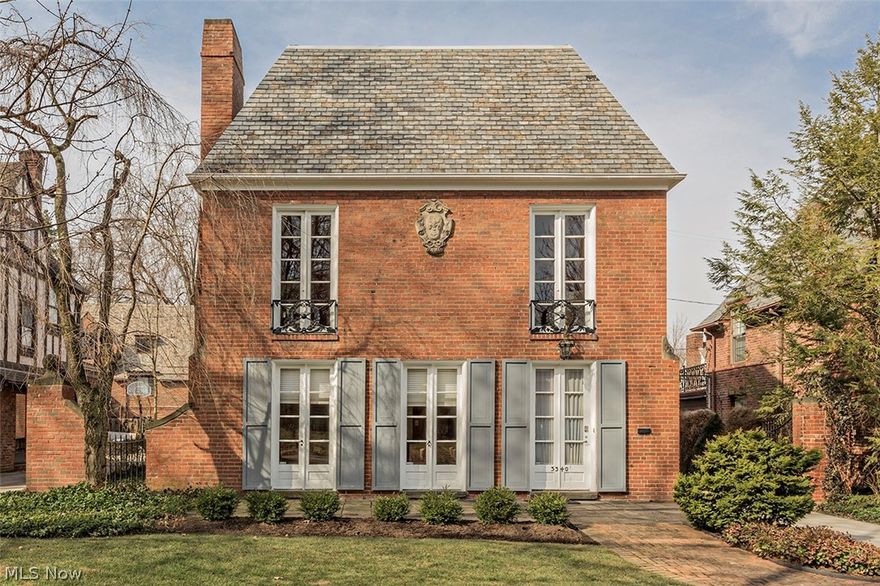 Sophisticated, elegant architectural gem in the heart of the Fernway neighborhood of Shaker Heights. The first floor has an inviting foyer, dining room with fireplace and floor to ceiling glass doors that open to the outside, an updated, eat-in kitchen with island and new stainless steel appliances. There is a den with builtins, first floor full bath and laundry room! The second floor has a stunning great room with hand-carved fireplace, hard-carved scottish wood accents and floor to ceiling glass doors that open to juiette balconies. The master bedroom has a bow window with window seat and two closets. The updated bath has walk-in shower and heated floors. Updates include concrete driveway, central air, electrical panel upgrade, sprinker system, attached garage and newer windows. There is also a full basement. The current dining room could be used as the living room and the den used as the dining room if desired.