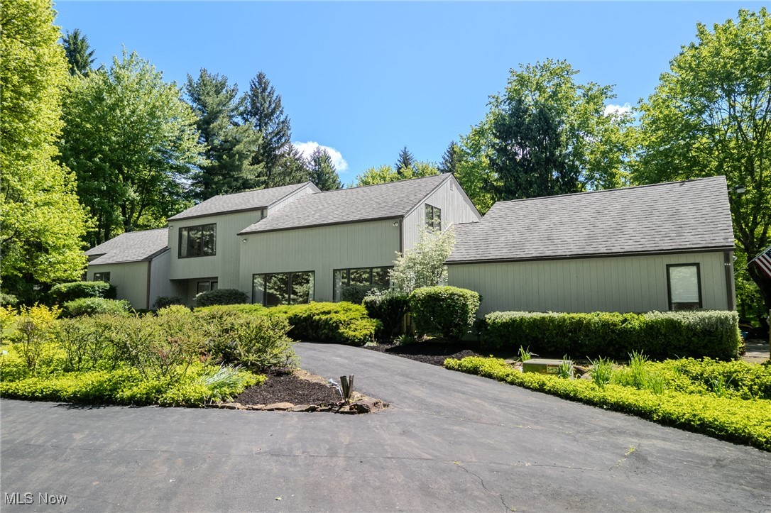 Tucked away in the middle of a beautiful 5 acre lot, this desirable western Novelty location & custom built home will impress with its spacious rooms & serene private views of its wooded & meadow like surroundings. Enter through the front door & large foyer, through the double doors you will be wowed at the large main living room paired with the two-story, sprawling windows overlooking the private backyard, allowing natural light to fill the room. With a stone wood burning fireplace, detailed/custom wall decor, built in bookshelves & wet bar! Great for hosting gatherings of all types. Spacious Kitchen featuring an eat-in island w/ ample storage & cooktop stove, Built-in desk, butlers pantry & Space for Kitchen table. Leading to the formal dining room that flows into the formal living room with views of the front yard. The main level living quarters hosts, the first bedroom w/ full bathroom off the hallway & master bedroom. The master features a vaulted ceiling, full bath, walk in closet & private deck. Upstairs you will find the additional bedrooms & Loft space overlooking the family room, fireplace & two story windows with the views of the backyard meadow. Great for a rec room or office area. Off the loft is a large attic space, as well as, the remaining two bedrooms & full bath. A spare bedroom that can be used as a play/study room, office, gym or storage. One of the bedrooms has a bookcase that duals as an hidden door for more storage space! The Basement offers even MORE space for entertaining but another full wet bar & fireplace! With an access stairwell to the 4 car garage, great for a private gym/art studio! Water softener and central vacuum. The 4 car garage offers vaulted ceiling with loft for even more storage.
Outside, you’ll love the surrounding wooded lot, with sprawling open space & meadow, large deck & quiet privacy. Easy access to Chagrin Falls, private schools, restaurants, golf, & parks; & to highways 271 and 90, and ST RT 306.