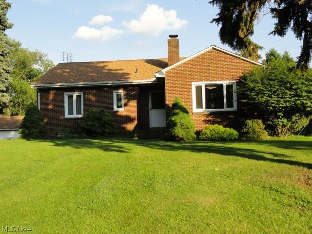 Privacy minutes from all amenities awaits you in this 2 BR, 1.5 BA brick home on 3.37 acres with a 5 car detached garage w/separate electric. Hardwood floors. Finished bsmt room could be 3rd BR -currently used as a den. Nice deck & patio w/hot tub.